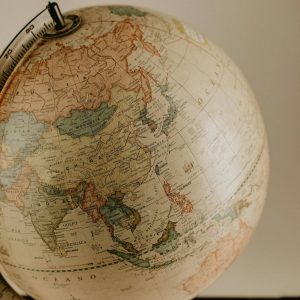 A vintage globe displaying the continents of Asia and Europe in sepia tones, ideal for travel concepts.